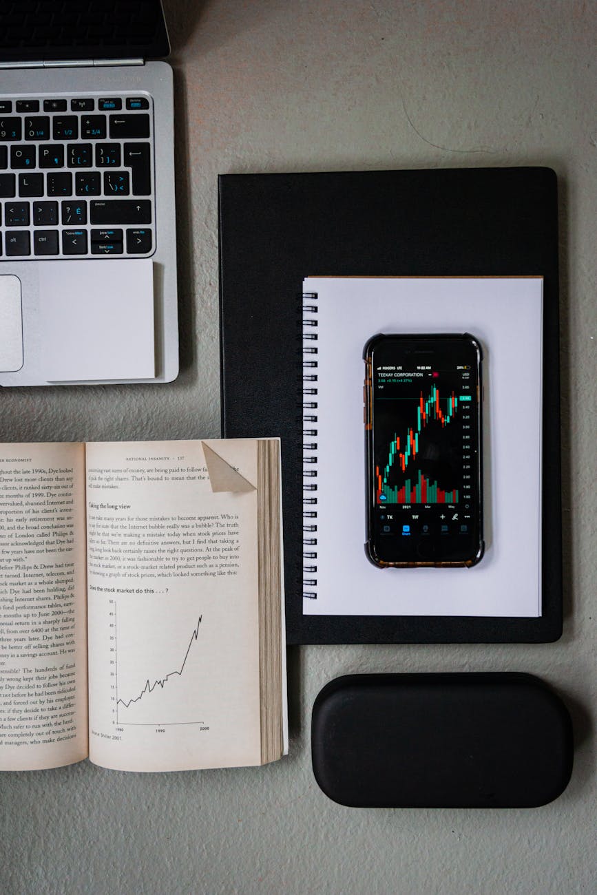 a smartphone and an open book with graphs
